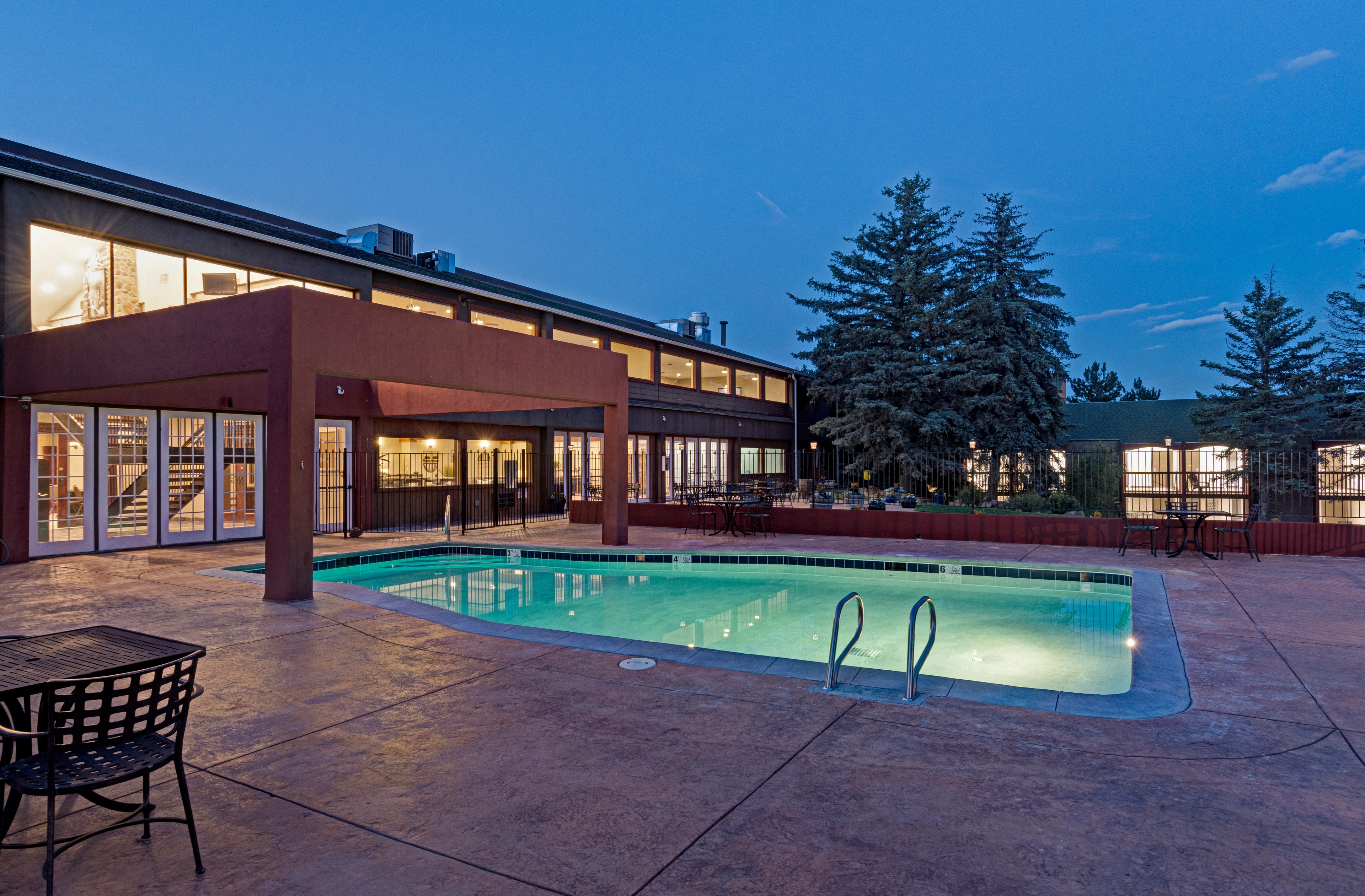 Seasonal outdoor pool beside the Mountain Springs Recovery campus at dusk
