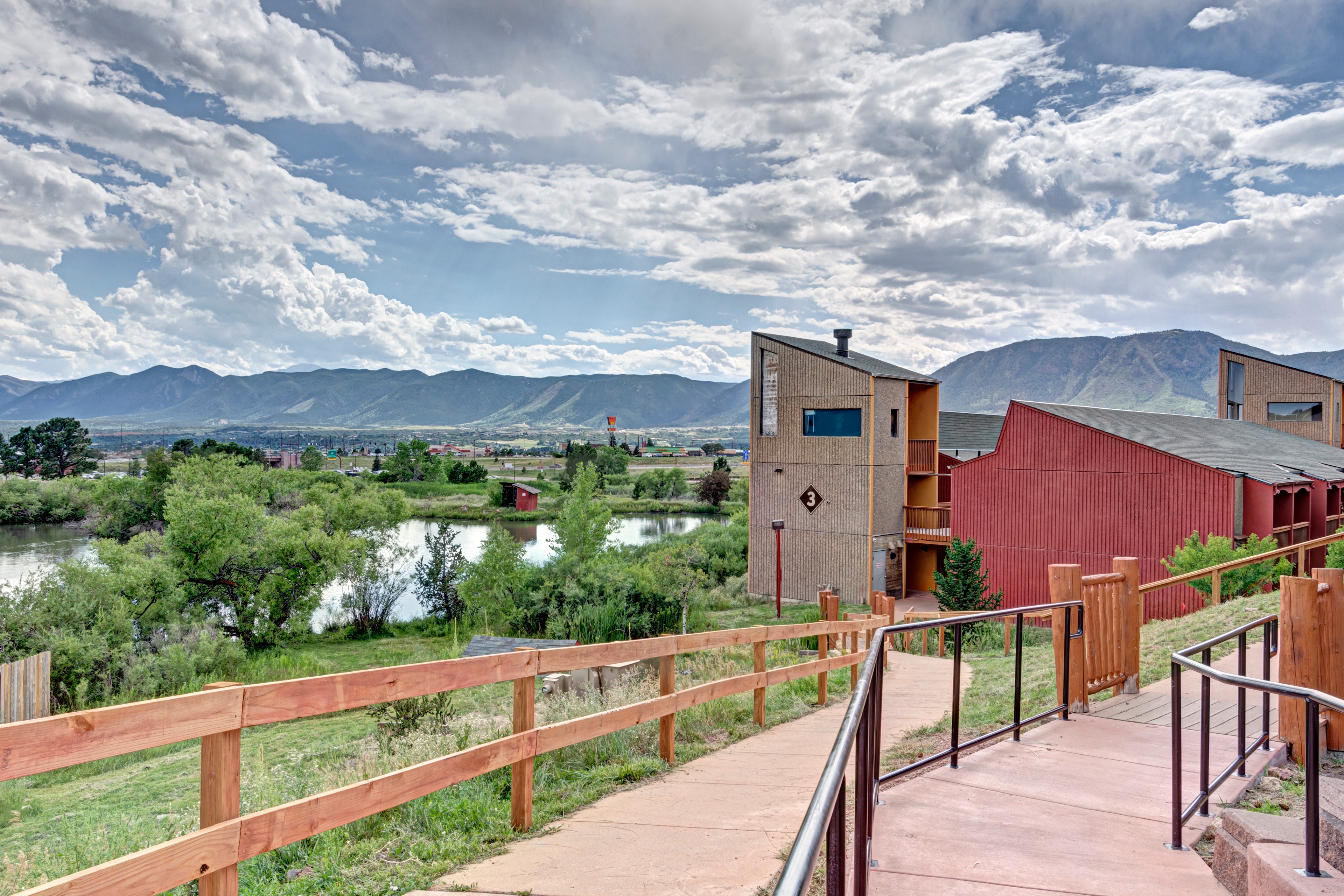 Mountain Springs Recovery campus buildings, pond and Colorado Front Range in daylight